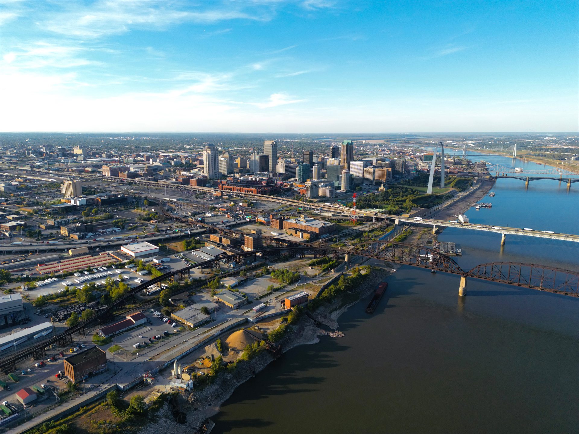 Aerial photograph of the Gateway South site on the Mississippi riverfront, with the Gateway Arch, Busch Stadium, and downtown St. Louis beyond